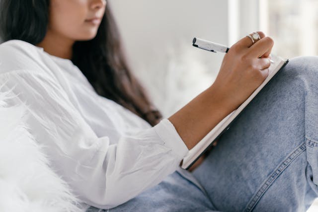 woman writing in her journal